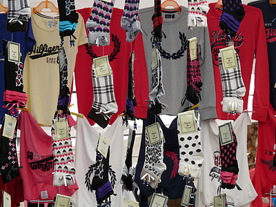 assorted-color shirts and socks hang near wall thumbnail