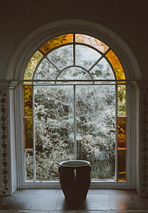 black and white ceramic cup beside window glass thumbnail