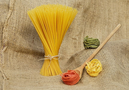 assorted-color pasta with brown wooden ladle thumbnail