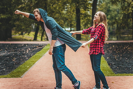 woman pulling the man's hooded jacket thumbnail