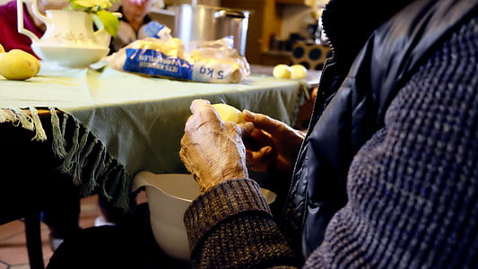 person holding peeled potato thumbnail
