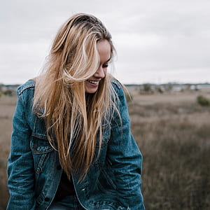 woman wearing denim jacket in the field thumbnail