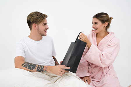Man and Woman Holding Black Tote Bag thumbnail