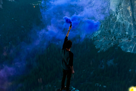 person spraying paint on top of high place thumbnail