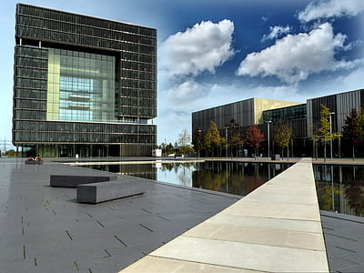 curtain wall building with pool in front thumbnail