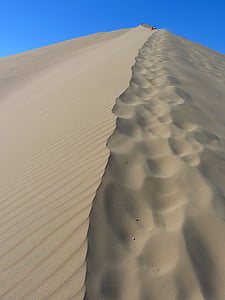 people on top of sand hill thumbnail