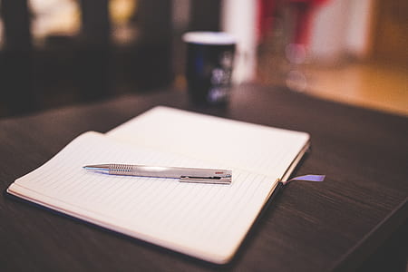 gray pen on white notebook thumbnail