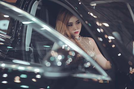 woman sitting on black vehicle at daytime thumbnail