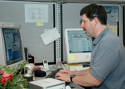 man in front of desktop computer thumbnail