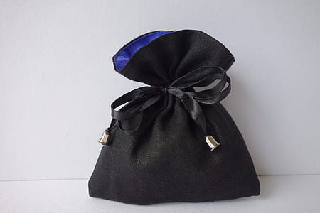 black drawstring purse on white surface thumbnail