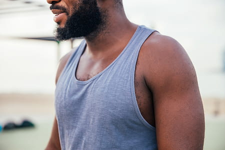 A beared young African man in tanktop thumbnail