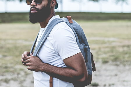 man wearing white crew-neck t-shirt and gray backpack thumbnail