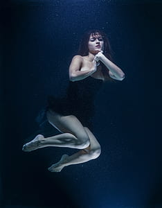 woman wearing black strapless dress underwater thumbnail