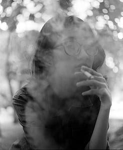 gray scale photo of woman smoking thumbnail