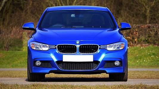 blue BMW car parked on gray road thumbnail