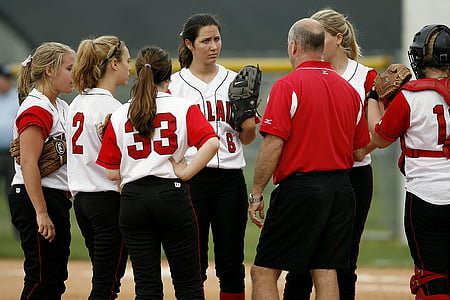 group of women baseball players talking a strategy at daytime thumbnail