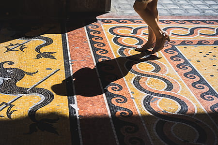 person walking on brown and black pavement thumbnail