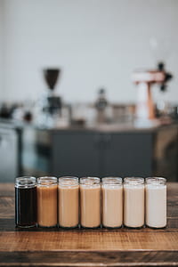 selective focus photograph of seven clear glass bottles on wooden surface thumbnail