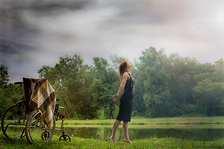 woman standing beside wheelchair thumbnail