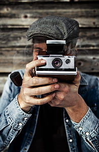 person using instant camera thumbnail