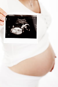 person holding ultrasound paper thumbnail