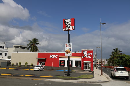 white vehicle parked at KFC parking lot near KFC shopfront during day thumbnail
