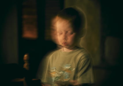 closeup photo of boy wearing gray crew-neck t-shirt thumbnail