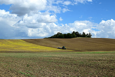 green tractor on green fields thumbnail