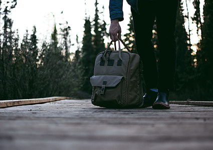 person carrying gray bag thumbnail