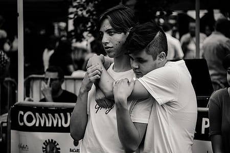 Grayscale Photography of Man Hugging Each Other thumbnail