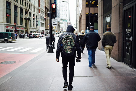 man wearing backpack walking on the street thumbnail