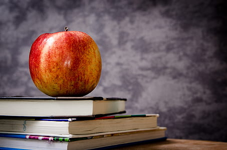 red apple on top of three books thumbnail