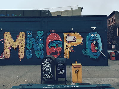 three assorted-color mailbox near graffiti wall thumbnail