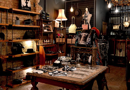 assorted-type of jewelries on square brown wooden table beside brown wooden rack thumbnail