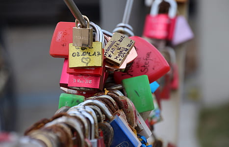selective focus photograph of several padlocks on link cable thumbnail