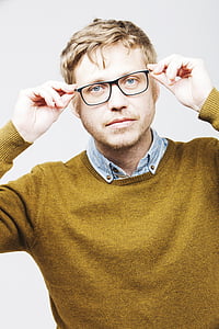 close photo of man wearing black framed eyeglasses and green crew-neck knitted sweater thumbnail