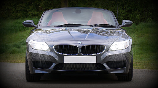 gray BMW vehicle on gray pave road thumbnail