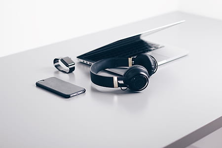 white laptop computer beside headphones thumbnail