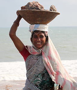 woman carrying bowl of stones thumbnail