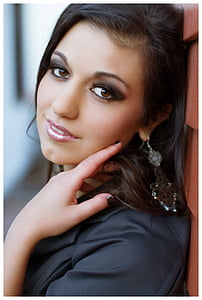 woman leaning on brown wall thumbnail