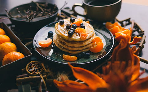 pile of pancake top with blueberry and orange fruits thumbnail