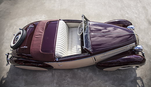 empty classic purple and silver convertible coupe on gray surface at daytime thumbnail