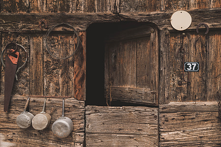 brown wooden door near three silver cooking pots thumbnail