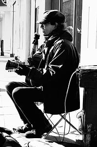 man playing guitar grayscale photo thumbnail