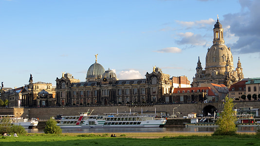landscape photography of cruise ship near castle thumbnail