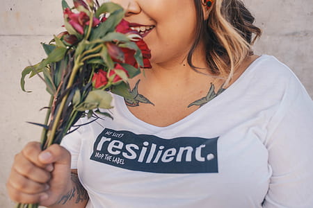 woman sniffing red flowers thumbnail
