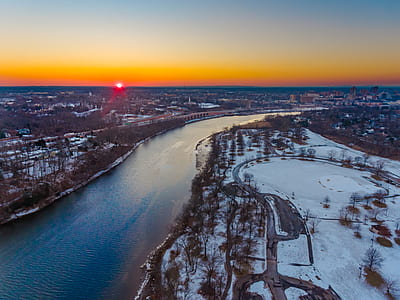 aerial photo of river beside trees during golden hour thumbnail