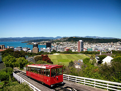 photo of red tram on bridge during daytime thumbnail