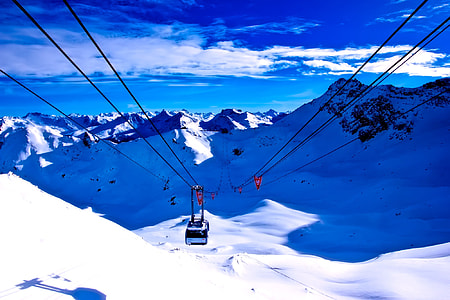 white cable car above snow field thumbnail