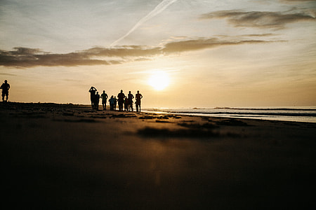 group of people standing on seashore thumbnail